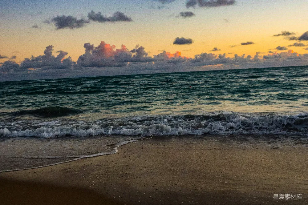 高清摄影 夕阳下的海洋有些云朵。