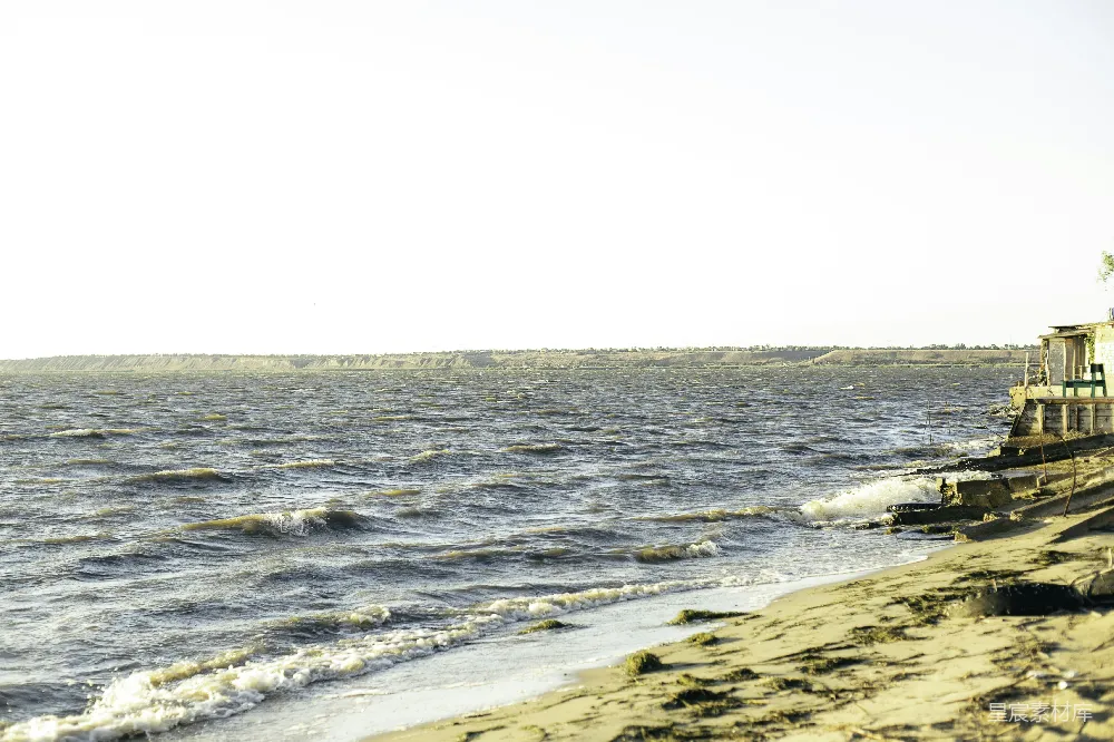 高清摄影 海浪拍打着一个小建筑附近的海岸。