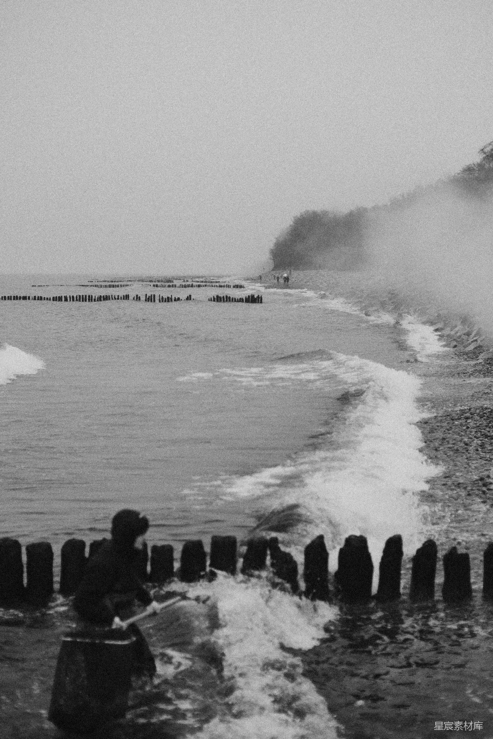 高清摄影 海边一个骑着冲浪板的人在波浪上。