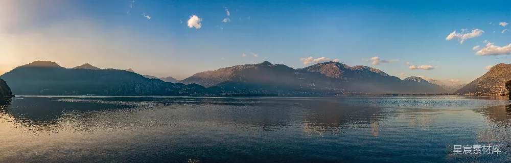 高清摄影 白天山下有水体，天空为蓝色