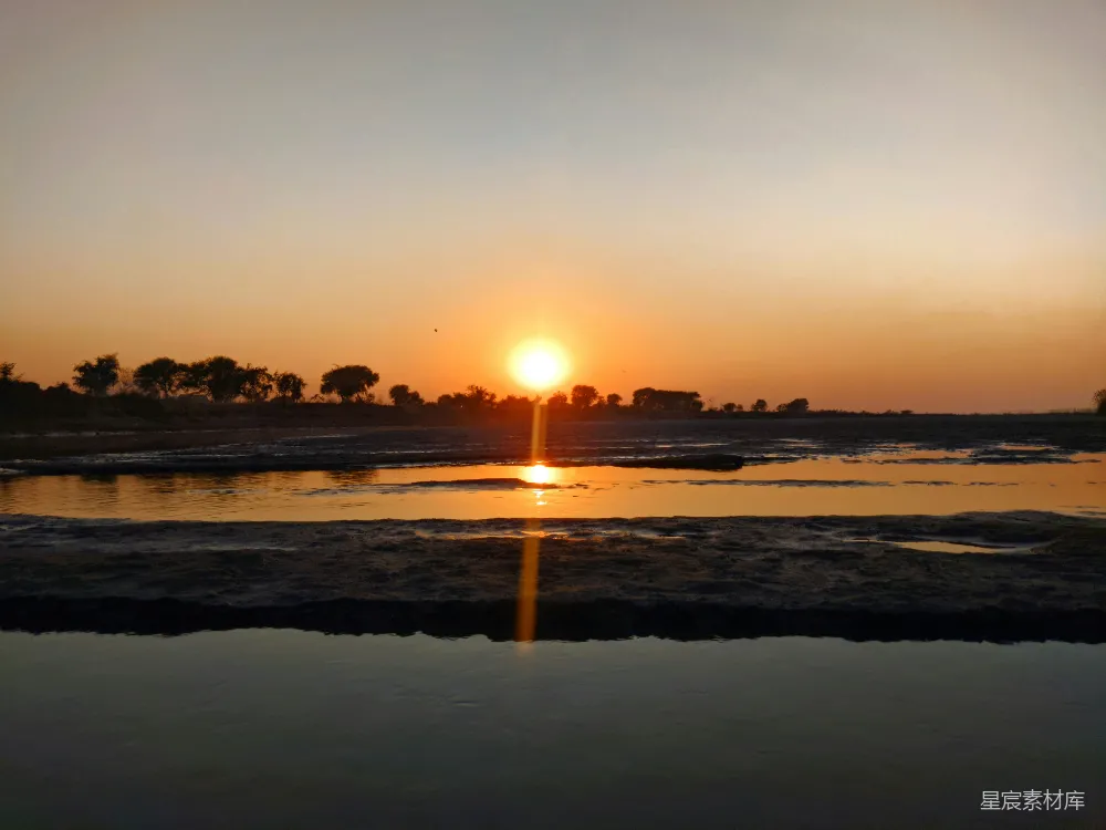 高清摄影 夕阳落下在一片水域之上
