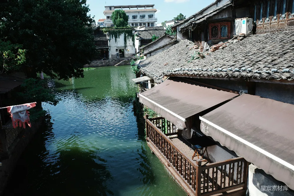 高清摄影 河边带有传统瓦片屋顶和檐篷的建筑。