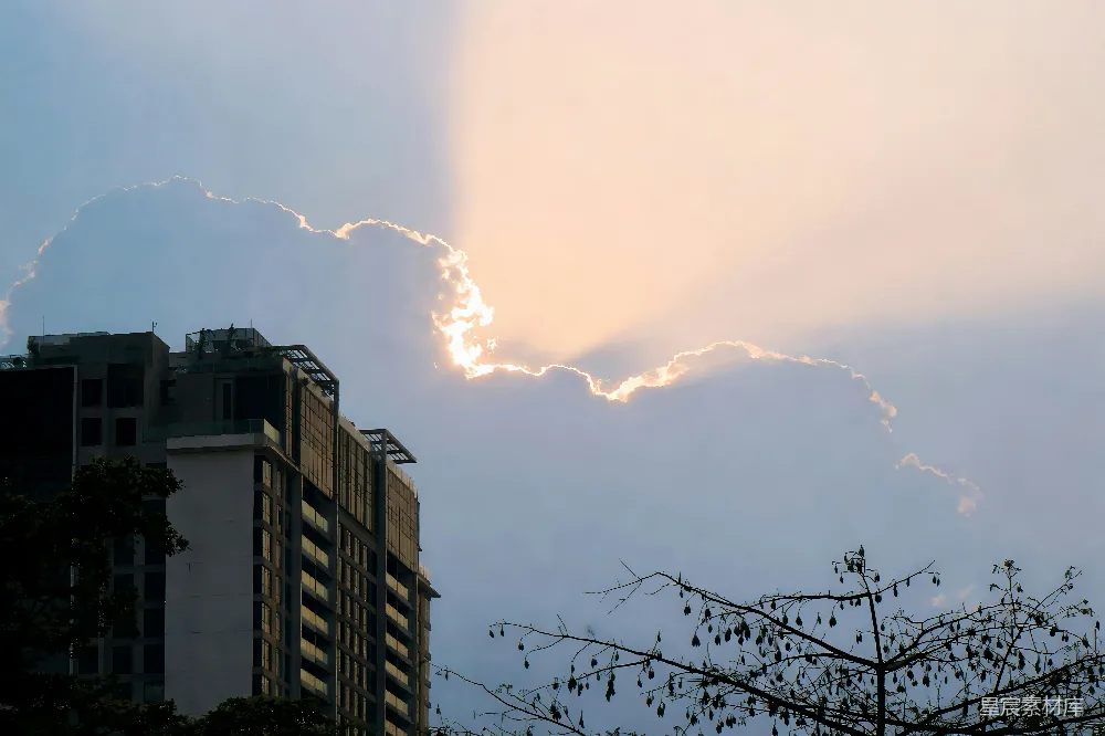 高清摄影 建筑物背后的阳光穿透云层
