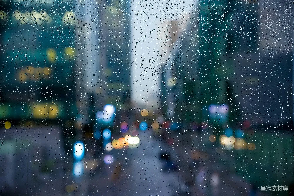 高清摄影 窗玻璃上滴落的雨珠，背景是模糊的城市街道。