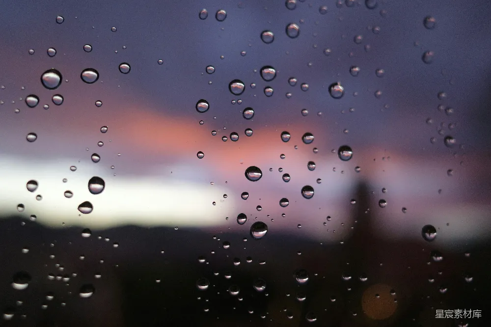 高清摄影 窗外夕阳映衬下的雨滴 Drops on a window with a sunset in the background.
