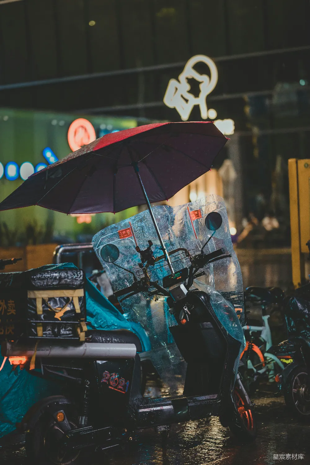 高清摄影 一辆带伞的滑板车停在雨中