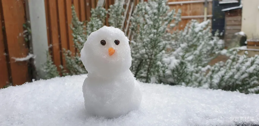 高清摄影 白天覆盖着积雪的地面上的白色雪人
