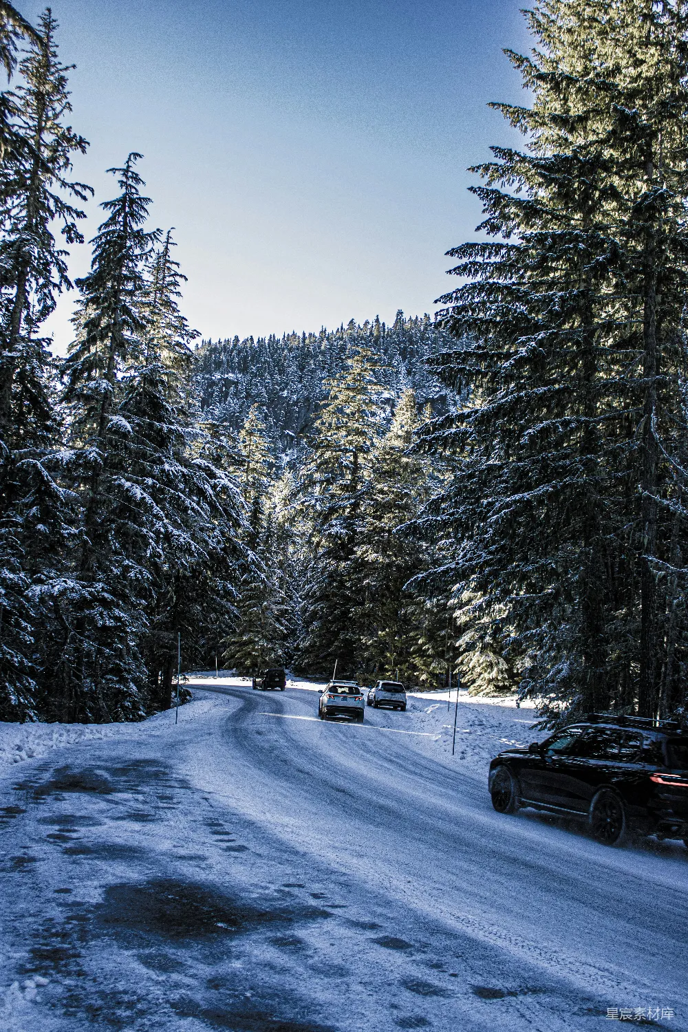 高清摄影 雪覆盖的道路，两侧停着汽车。