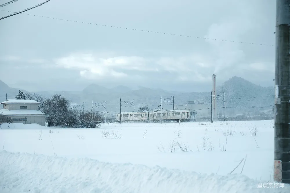 高清摄影 一列火车穿越着覆盖着白雪的乡间景色