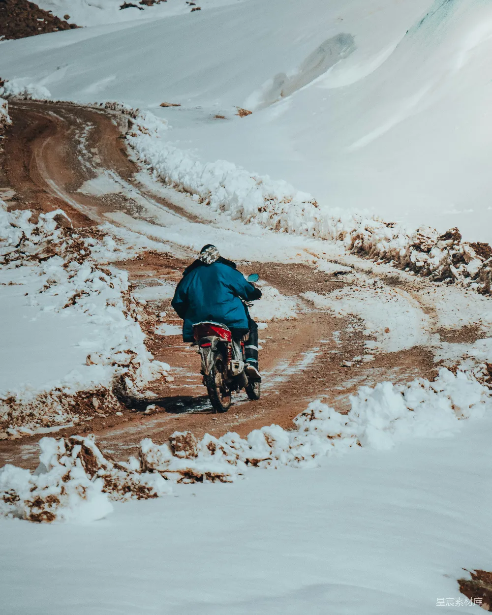 高清摄影 一个男人骑着摩托车在一条被白雪覆盖的道路上行驶