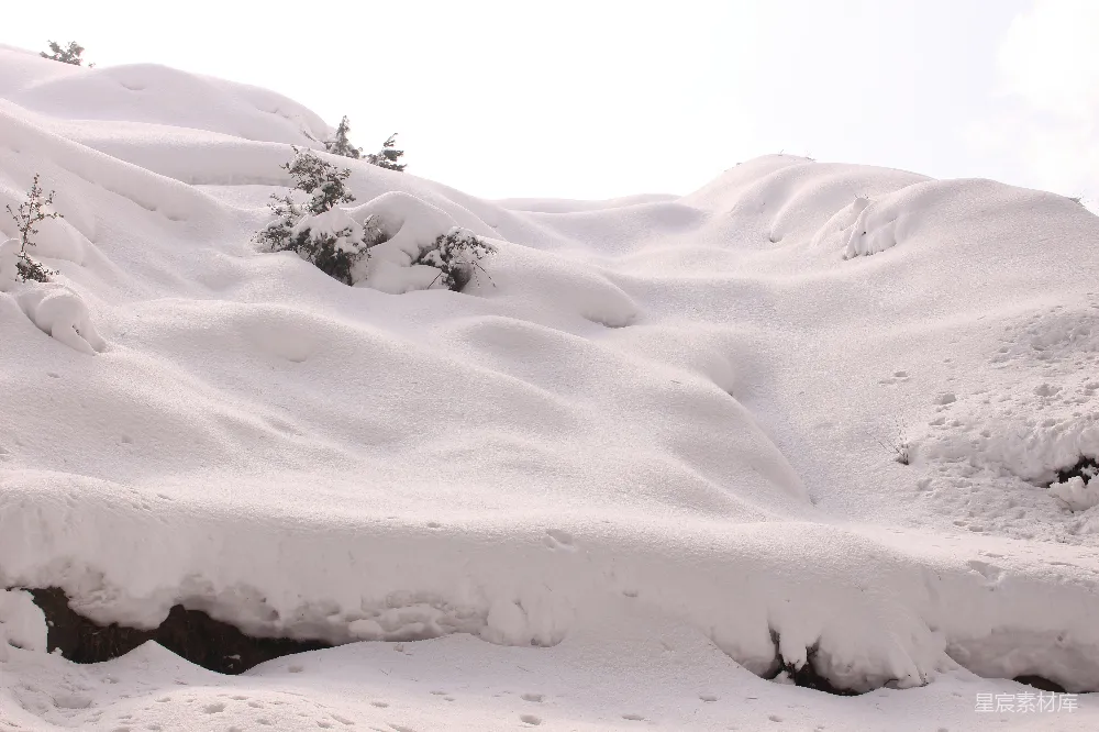 高清摄影 一个男子在覆盖着积雪的山坡上滑雪板