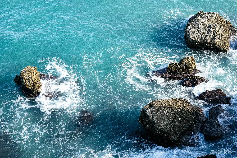 高清摄影 一堆岩石坐落在一个水体之上
