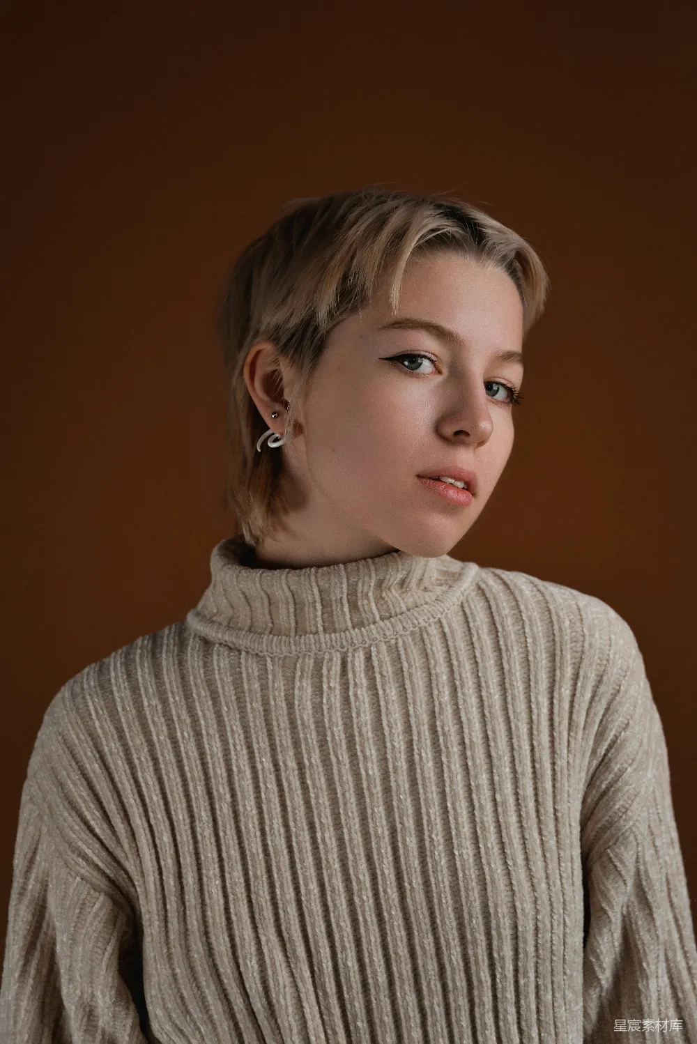 高清摄影 一个穿着 turtle neck 毛衣的女人正在拍照。