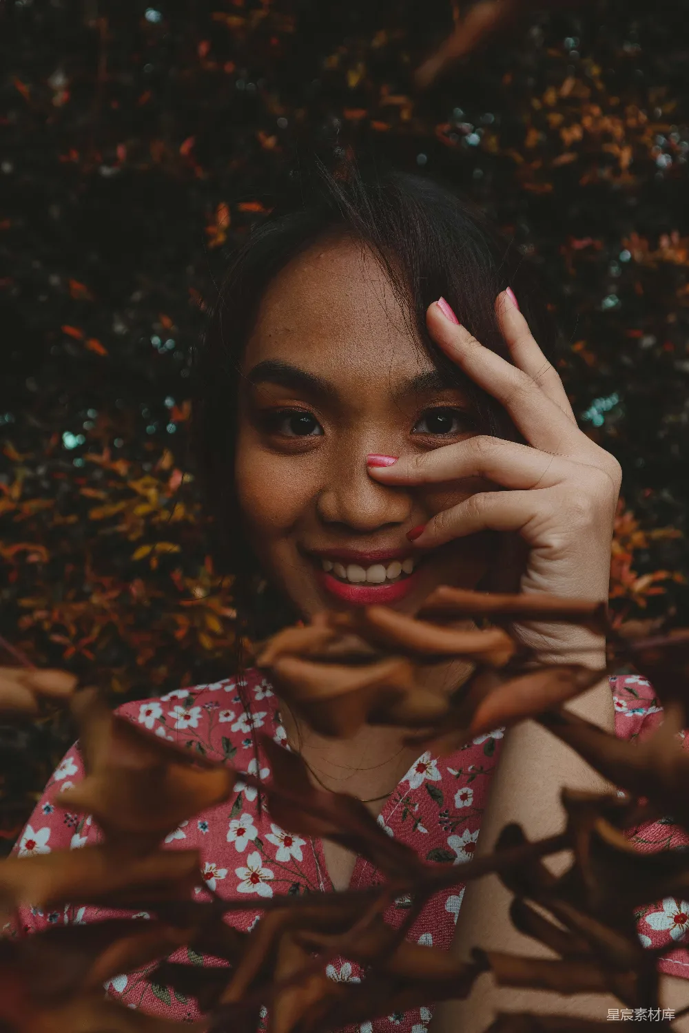 高清摄影  一个穿着粉色花衬衫的女人举手捂住脸