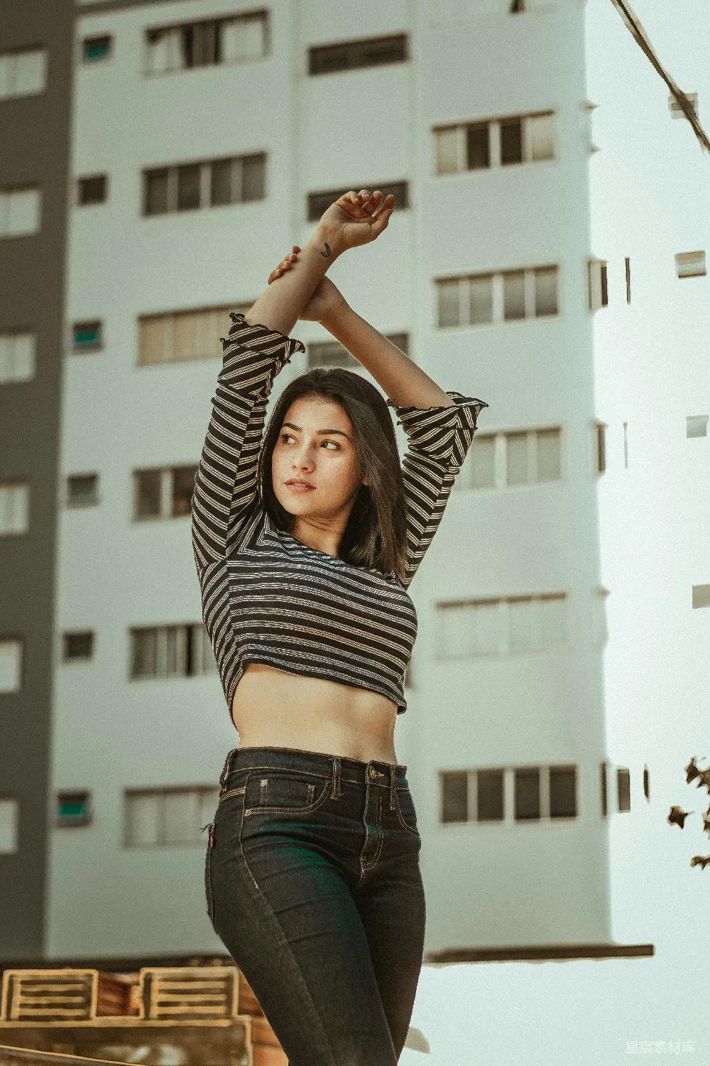 高清摄影 穿着灰色和黑色条纹长袖衫的女人正在用手腕