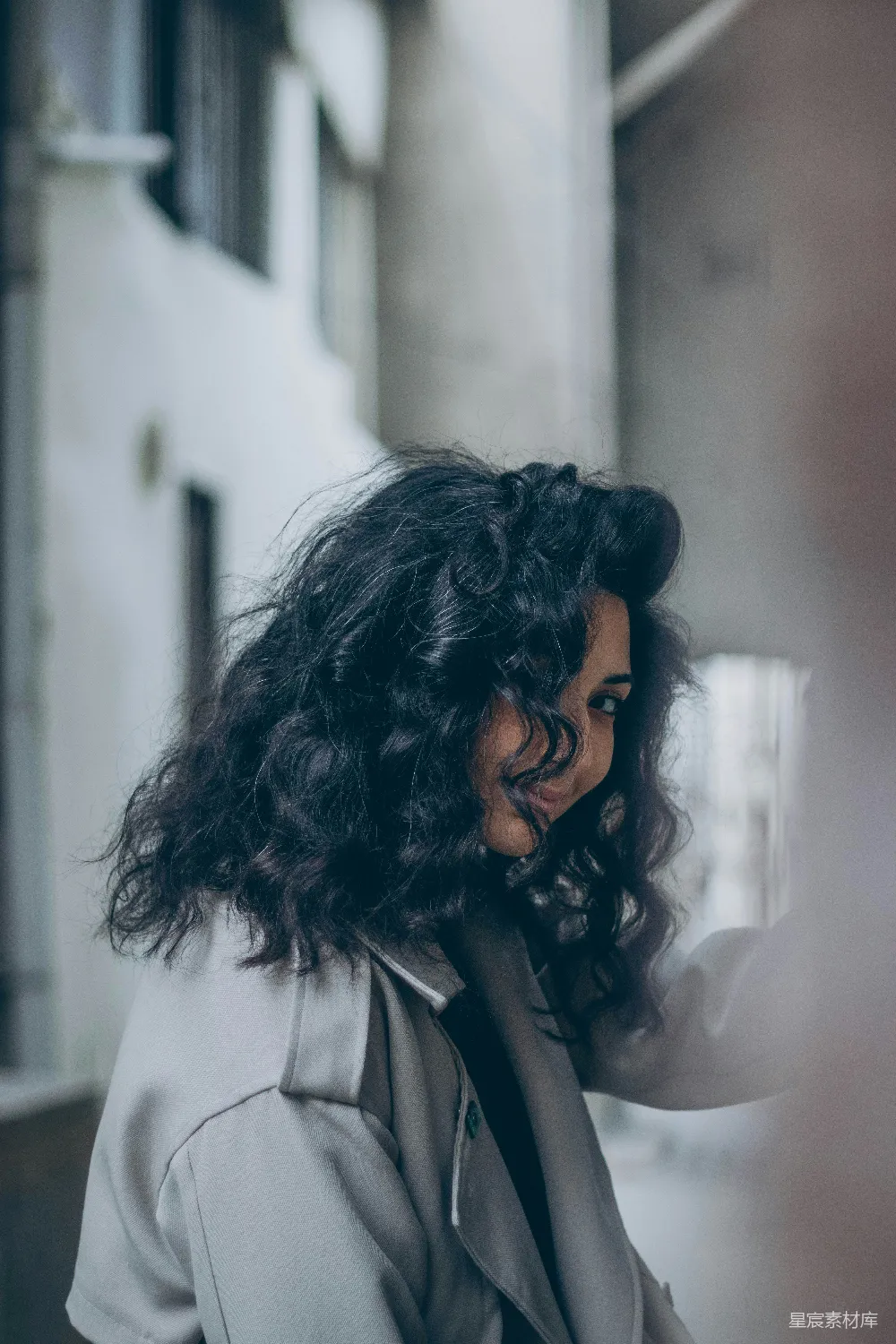 高清摄影  一个留有 curly hair 的女性正在看着她的手机。
