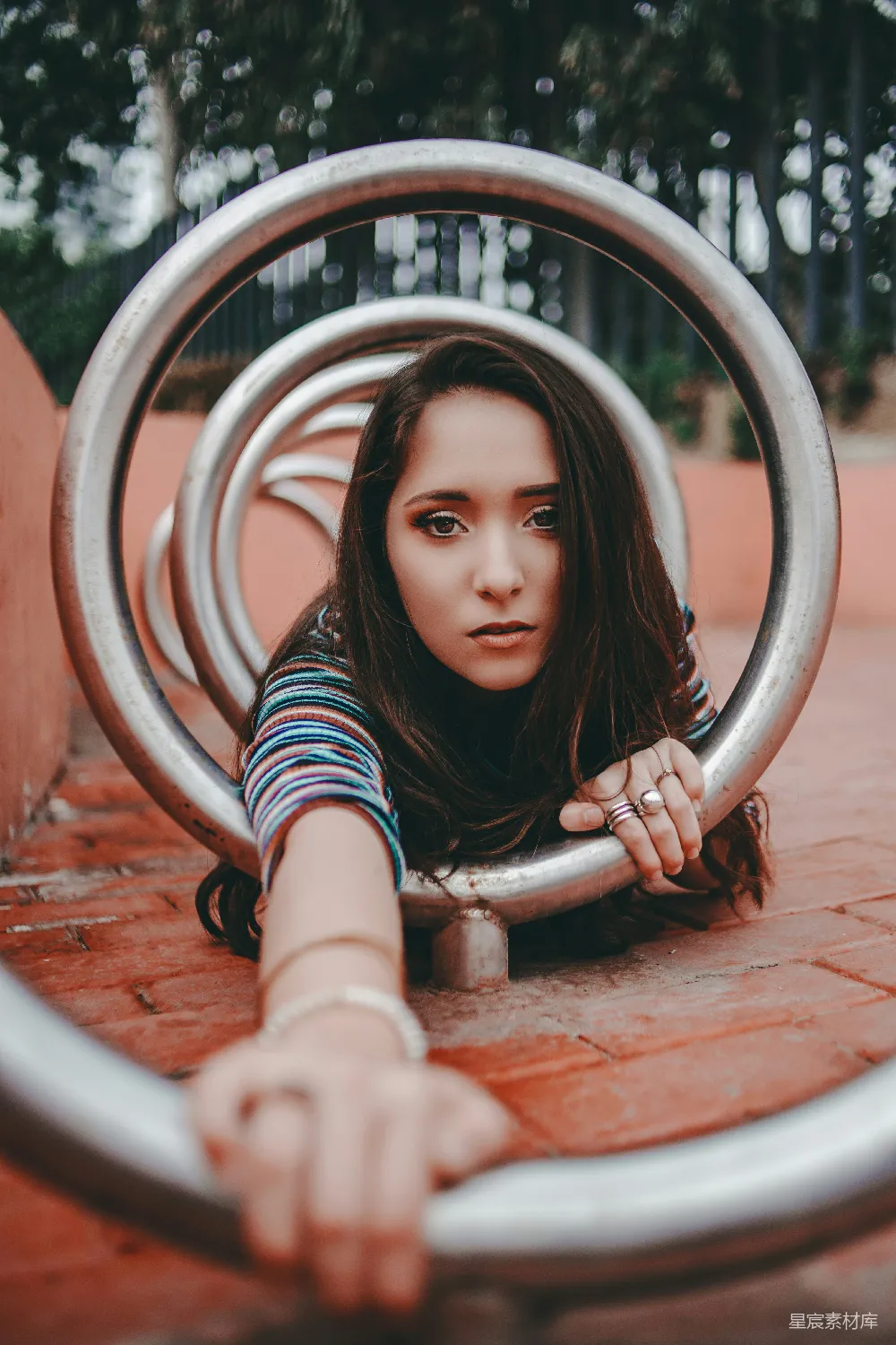 高清摄影  女人在圆形灰色金属杆上爬行