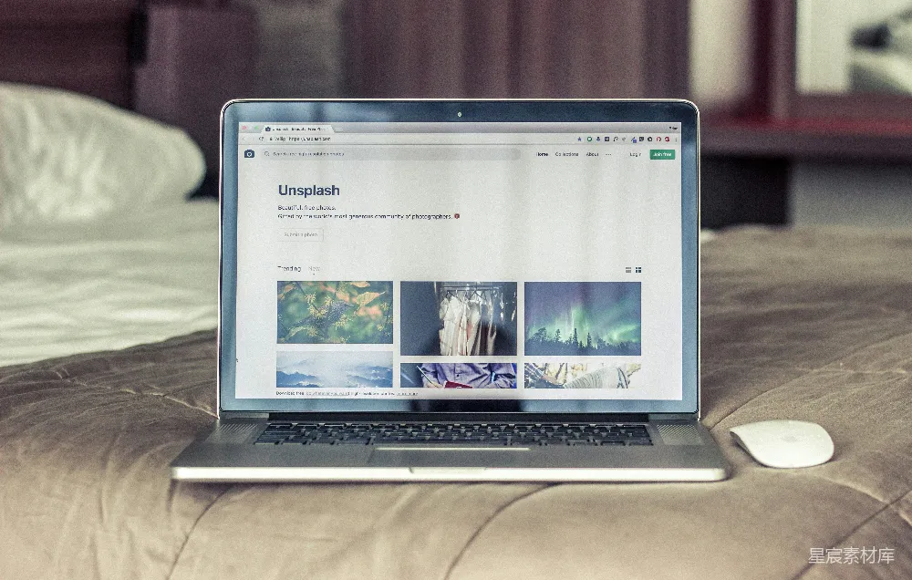 高清摄影 灰黑色的MacBook Pro放在床上。