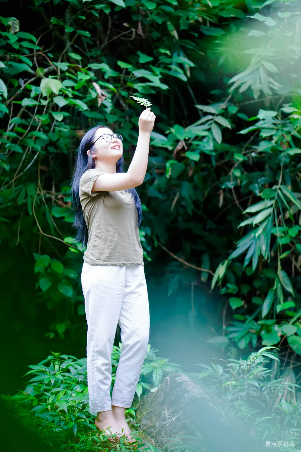 高清摄影 一个女人站在一片浓绿的森林前
