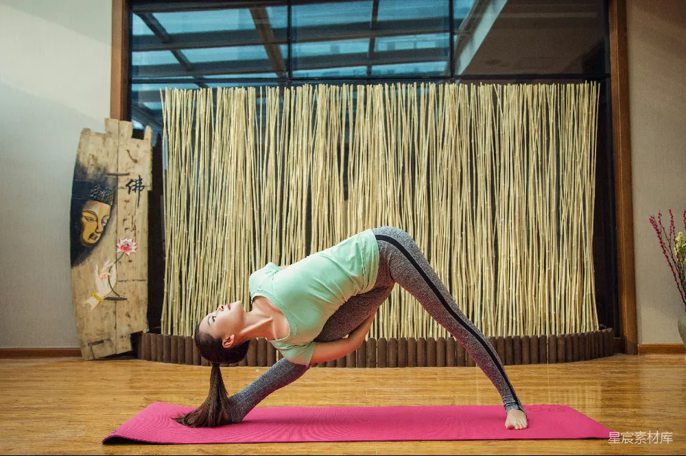 高清摄影  绿色上衣和灰色紧腿裤的女人在做瑜伽