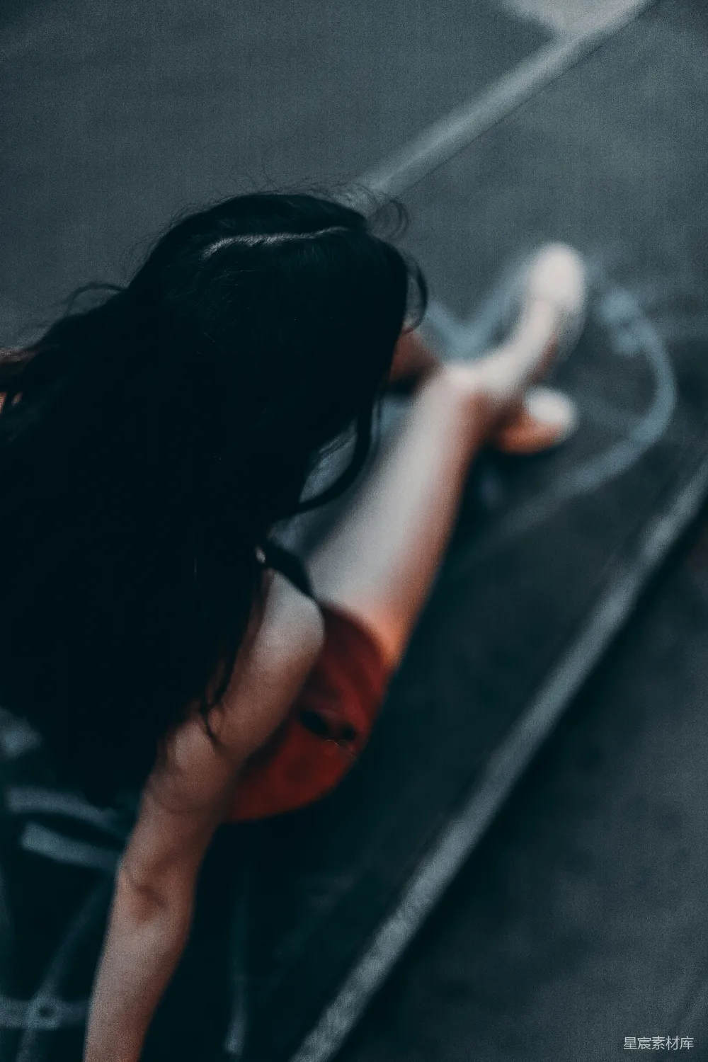 高清摄影 一个女人侧躺在地上，背对着摄像机。