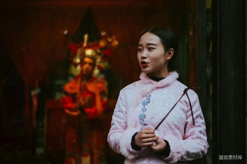 高清摄影  粉色 sweatshirt 穿着的女人手持一根棍子的浅景深摄影