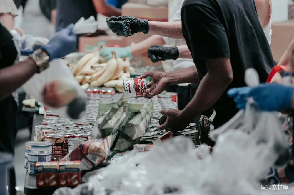 高清摄影 志愿者分发 canned food 捐赠