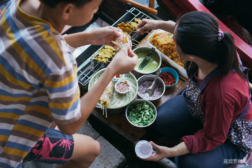 高清摄影 旅行 人物 一群人在桌上围绕着的食物旁坐着