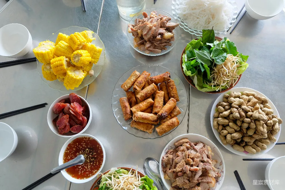 高清摄影  一张桌上摆放着各种越南菜肴和食材。