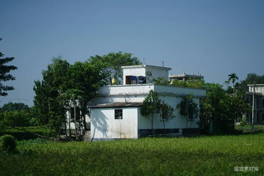 高清摄影  白色建筑被茂盛的绿树和草地环绕。