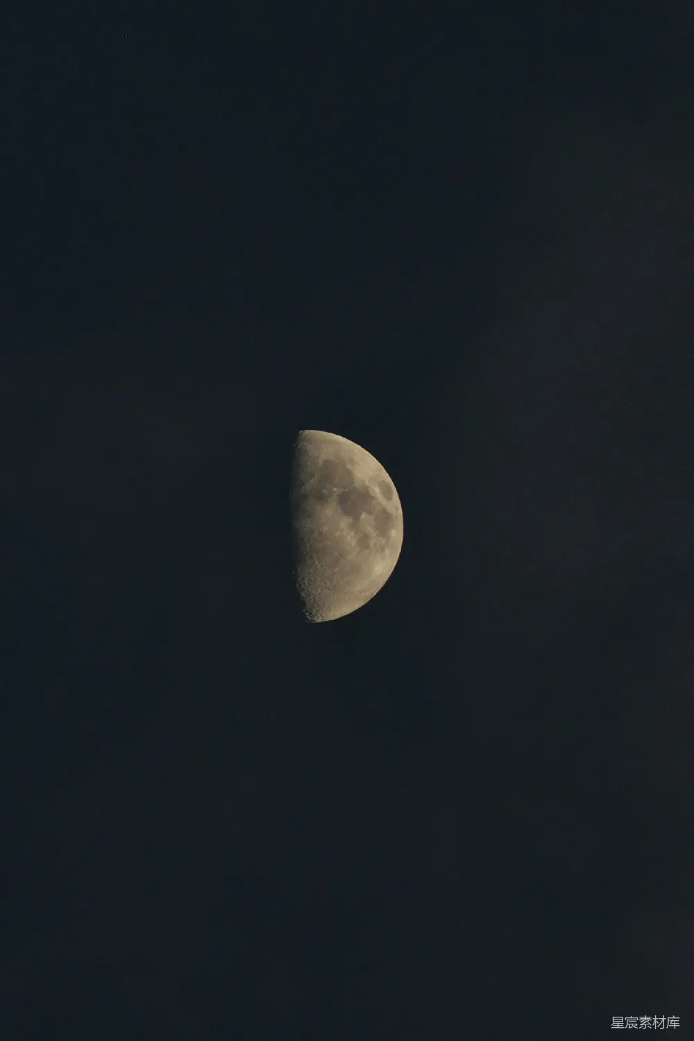半轮明月映衬黑暗的夜空
