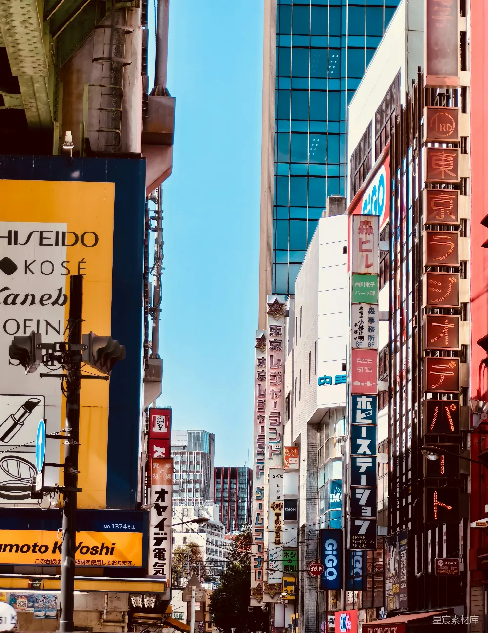 高清摄影  东京繁忙的街道，两旁排列着商店和标志。