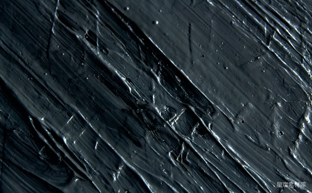 高清摄影  一张黑色表面的特写照片，上面有水珠。