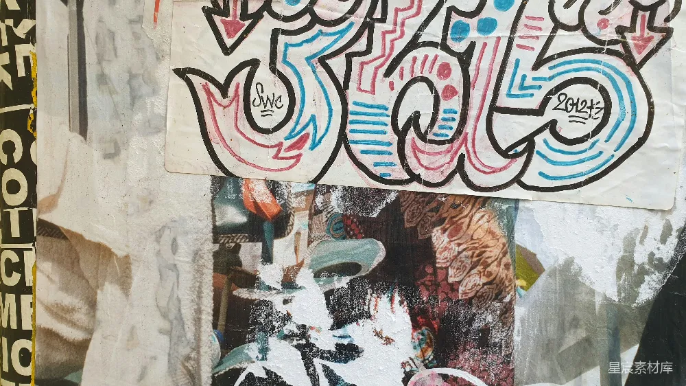 高清摄影  一个男人站在一堵布满涂鸦的墙旁边