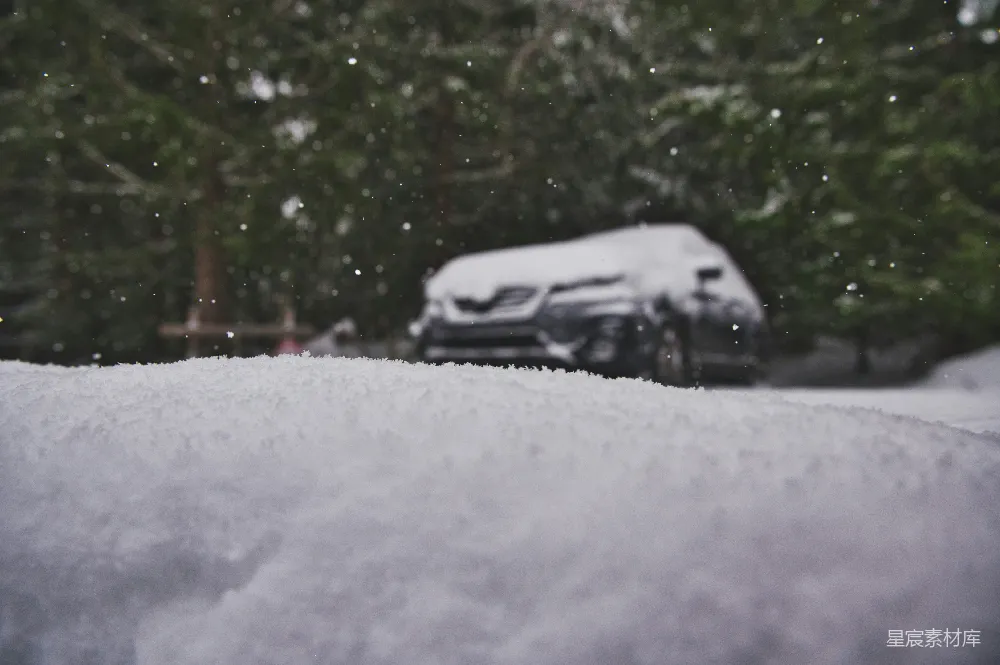 雪地里停着一辆白色的小汽车