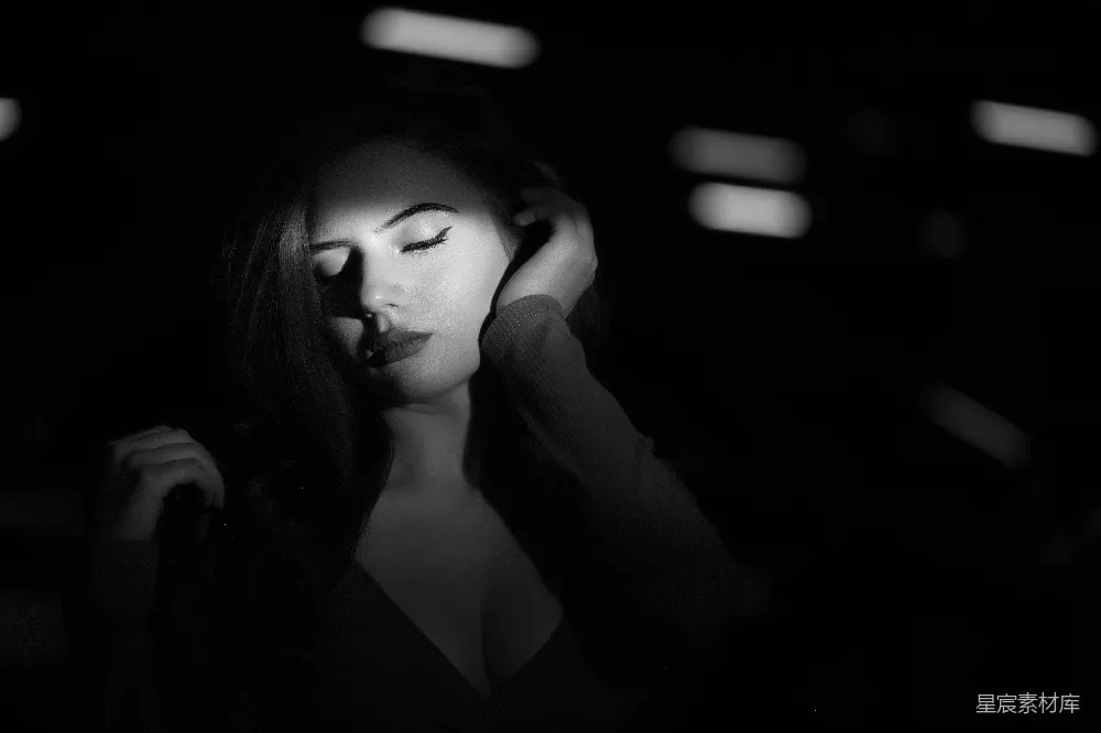 高清摄影  一个闭着眼睛的女人在黑暗中。