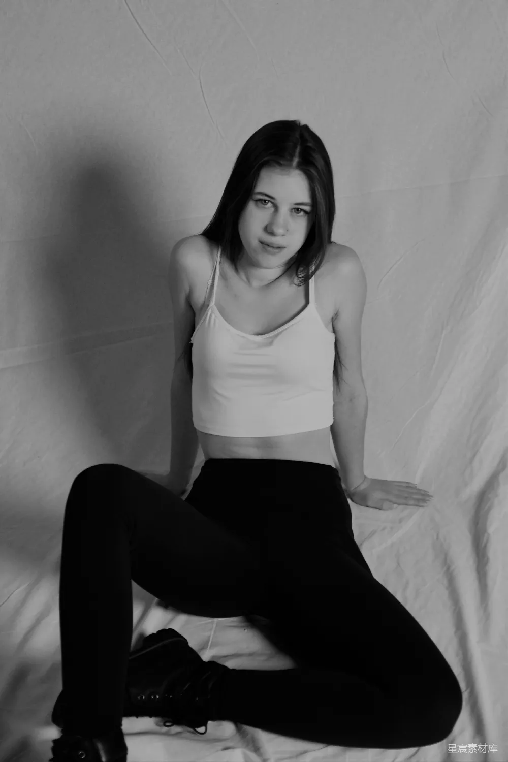 高清摄影 人物 一张黑白照片，照片中一位女子坐在床上。