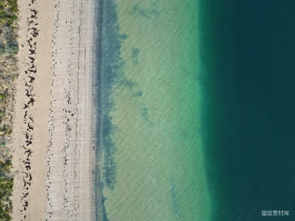 高清摄影  海滩的空中俯瞰图，人们在海滩上行走。