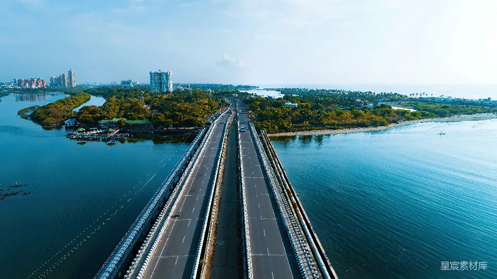高清摄影  现代桥梁横跨蓝水，通向城市景观