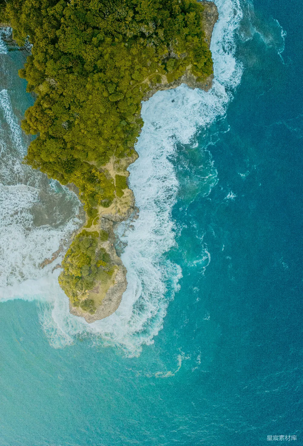 高清摄影  郁郁葱葱的绿岛海岸线的航拍视角，海浪拍打着岸边。