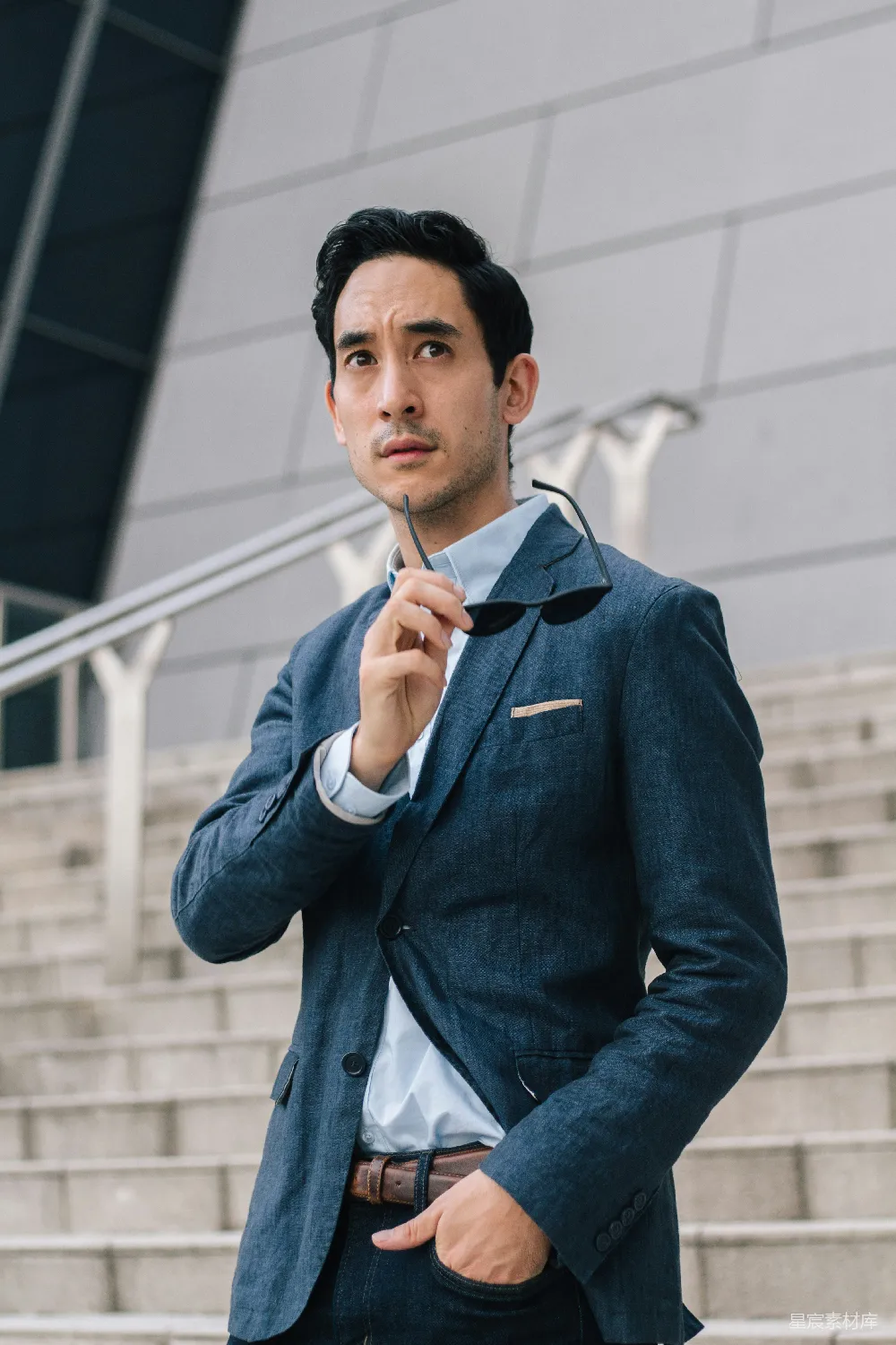 高清摄影  穿着蓝色西装夹克的男人双手托着下巴。