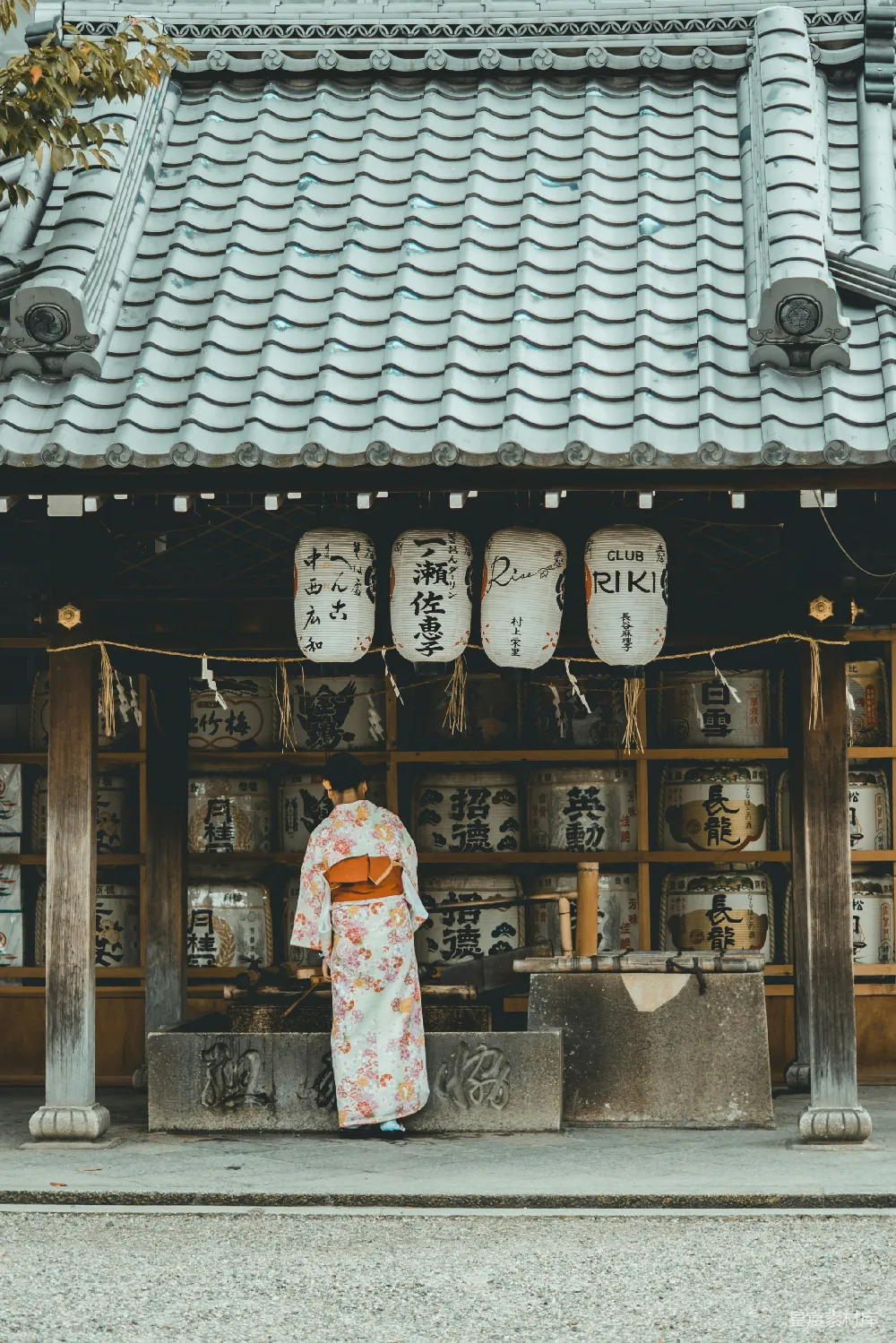 高清摄影 人物 自然 旅行 一位穿着橙白相间的和服的女人站在房子附近。