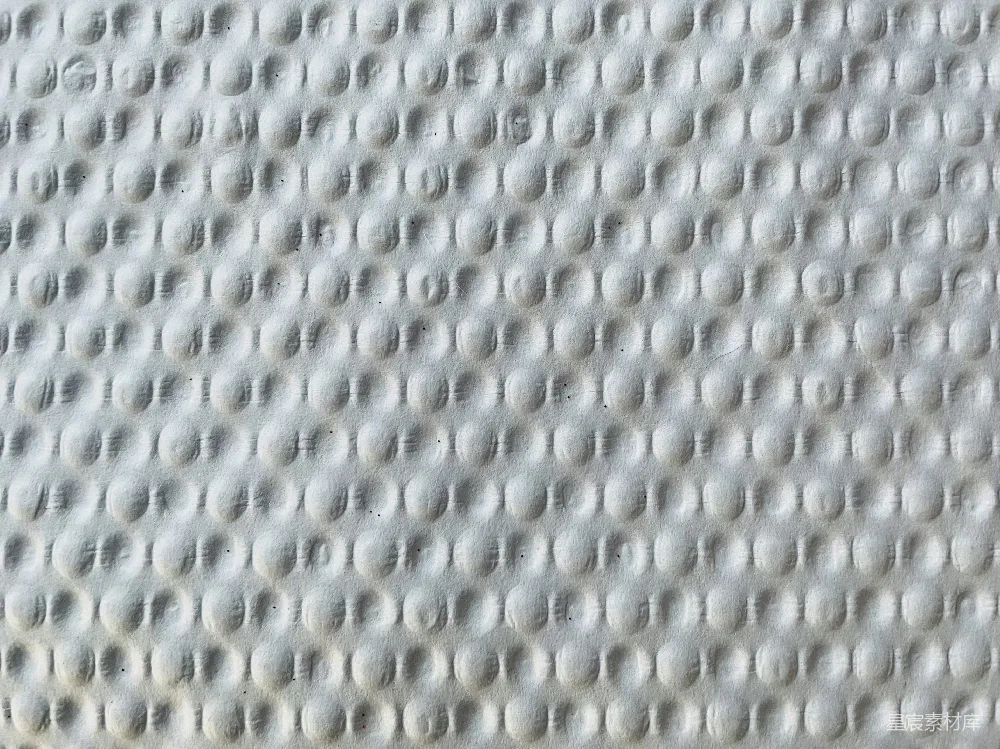 高清摄影  一张床垫的特写照片，上面有白色斑点。