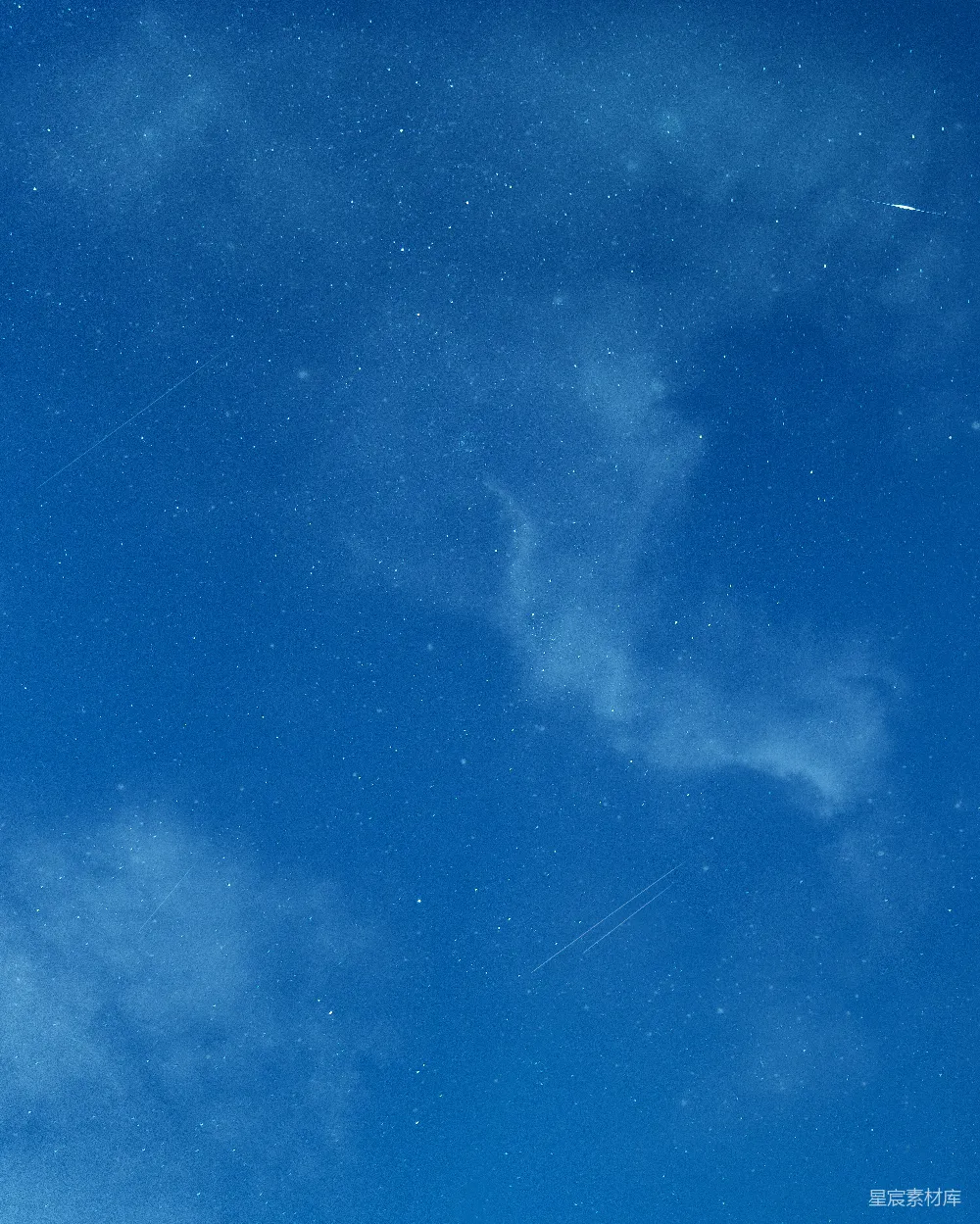 高清摄影  一片蓝天，星星点点，一架飞机在空中飞翔。