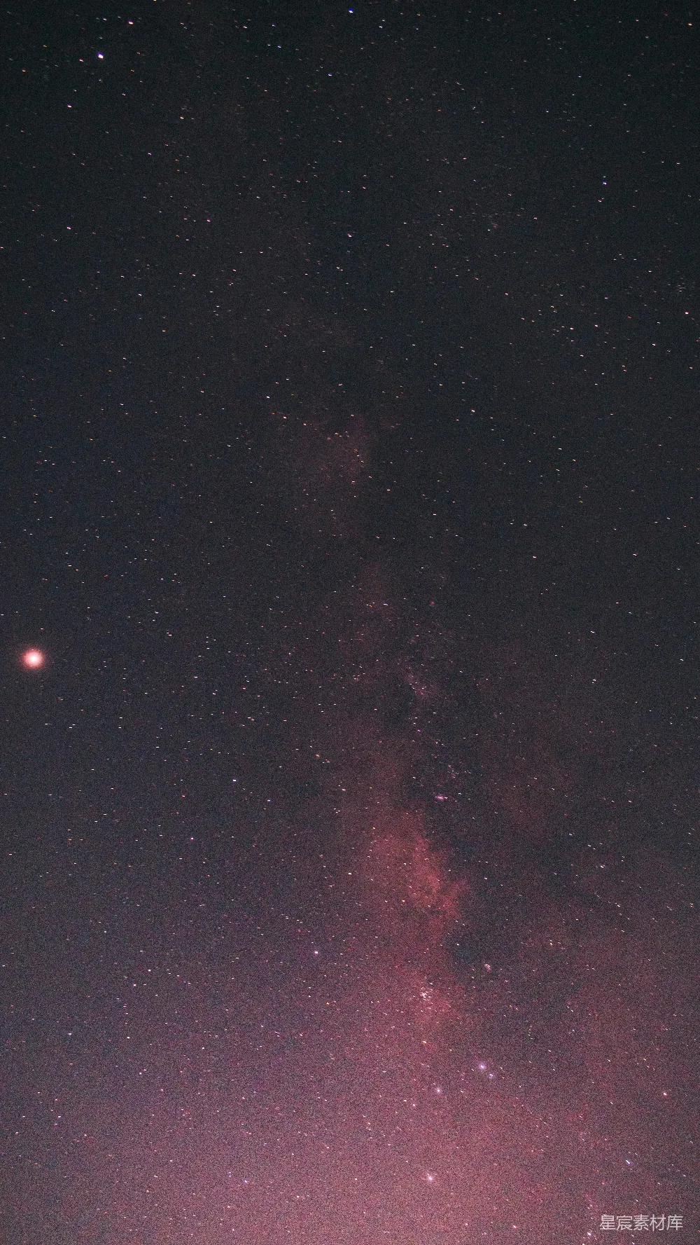 高清摄影  夜空中布满了星星，并且有一道明亮的粉红色光芒。