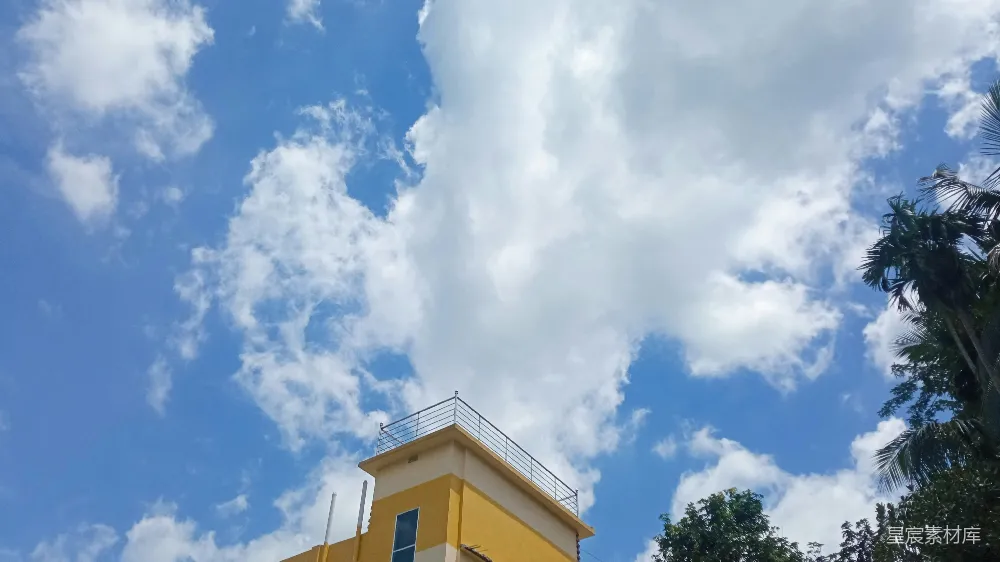 高清摄影  在多云的蓝天下的黄色建筑。