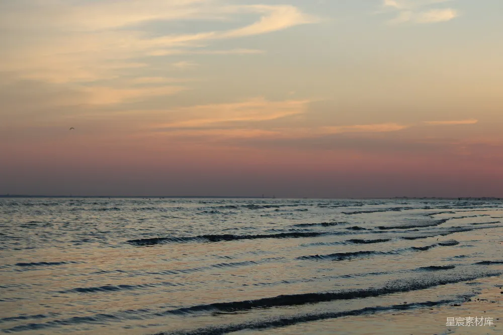 高清摄影 自然 一个沙滩，海浪翻滚，夕阳西下。