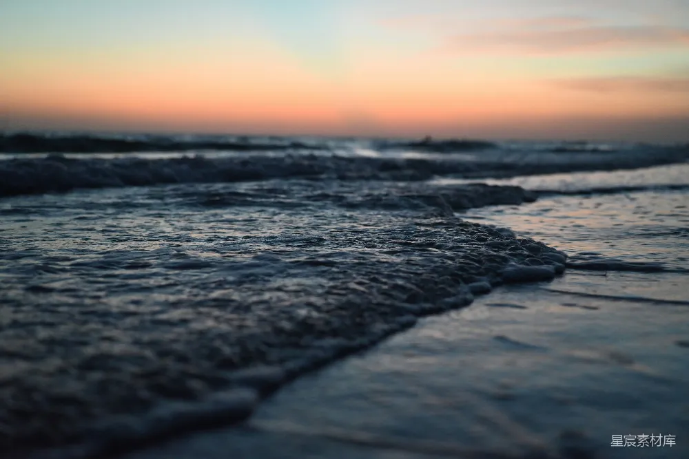 高清摄影  夕阳下，海浪轻拍着海岸。