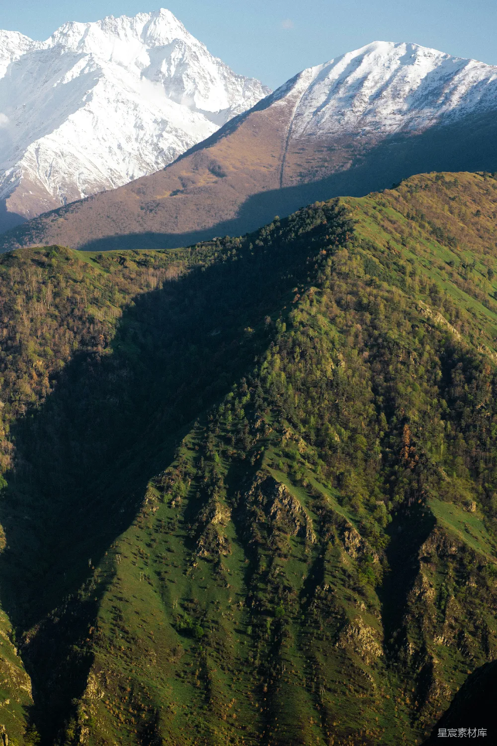 高清摄影  一座山脉，背景是被白雪覆盖的山峰。