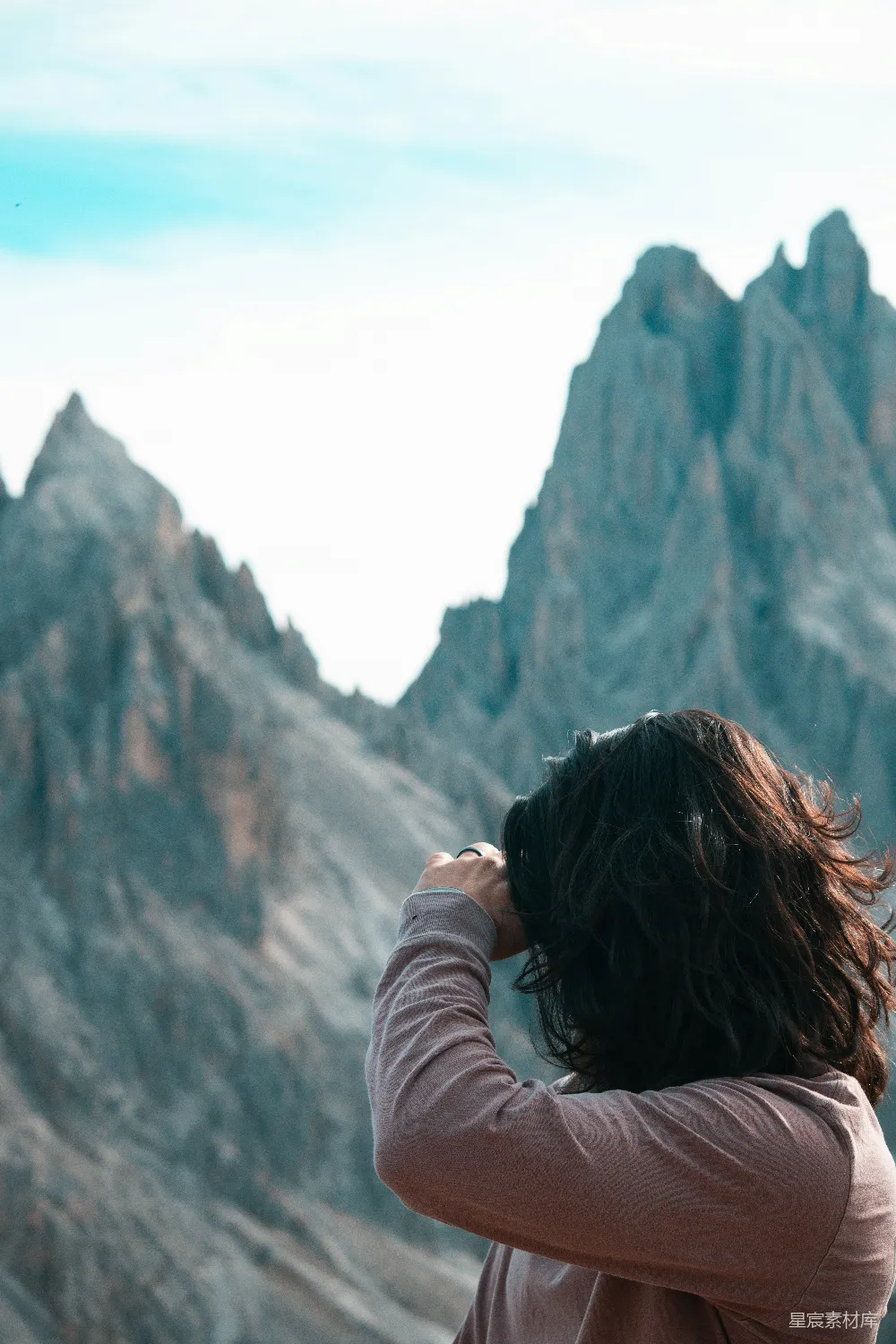 高清摄影  一个女人站在一座山前。